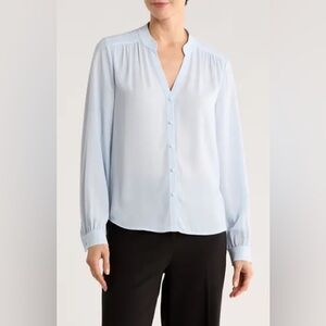 L'Agence long-sleeve blouse featuring a V-neckline and a flowy silhouette